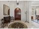 Elegant entryway with arched wooden door and decor at 11261 Macaw Ct, Windermere, FL 34786