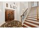 Elegant staircase with wooden steps, metal railing, and wine cabinet at 11261 Macaw Ct, Windermere, FL 34786
