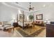 Main bedroom with king-size bed, sitting area, and access to patio at 11261 Macaw Ct, Windermere, FL 34786