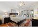 Main bedroom with king-size bed, access to outdoor patio, and hardwood floors at 11261 Macaw Ct, Windermere, FL 34786