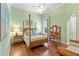 Serene bedroom with a wooden four-poster bed, hardwood floors, and a vanity at 11261 Macaw Ct, Windermere, FL 34786