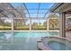 Inviting swimming pool with spa and screened lanai at 11261 Macaw Ct, Windermere, FL 34786