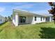 House with covered patio and grassy backyard at 1411 Clubman Dr, Davenport, FL 33896