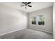 Well-lit bedroom featuring neutral walls and plush carpeting at 1411 Clubman Dr, Davenport, FL 33896