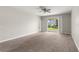 Spacious Gathering room with carpet flooring and sliding glass doors to backyard at 1411 Clubman Dr, Davenport, FL 33896
