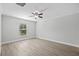 Bright bedroom with wood-look floors and a window with blinds at 656 Koala Ct, Kissimmee, FL 34759