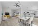 Open concept living and dining area with a modern kitchen and wood floors at 656 Koala Ct, Kissimmee, FL 34759