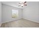 Simple bedroom with wood-look floors and a window with blinds at 656 Koala Ct, Kissimmee, FL 34759