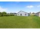 Large backyard with lush green grass and a view of the house's back exterior at 656 Koala Ct, Kissimmee, FL 34759