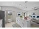 Open concept kitchen with island, white cabinets, and view to living room at 656 Koala Ct, Kissimmee, FL 34759