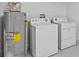 Neat laundry room with washer, dryer, and water heater at 656 Koala Ct, Kissimmee, FL 34759