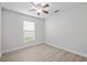 Bright bedroom with wood-look floors and window with blinds at 656 Koala Ct, Kissimmee, FL 34759