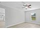 Bedroom with wood-look floors, a ceiling fan and view of kitchen at 656 Koala Ct, Kissimmee, FL 34759