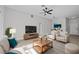 Bright living room featuring comfortable seating and a large flat-screen TV at 656 Koala Ct, Kissimmee, FL 34759