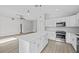 Open concept kitchen island with white cabinets and stainless steel appliances at 656 Koala Ct, Kissimmee, FL 34759