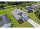 Aerial view shows a light blue house with a gray roof, driveway, and surrounding homes at 656 Koala Ct, Kissimmee, FL 34759