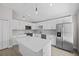 Modern kitchen with white cabinets, stainless steel appliances, and quartz countertops at 656 Koala Ct, Kissimmee, FL 34759