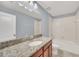 Bathroom with granite countertop and tub shower combo at 7642 Fairgrove Ave, Windermere, FL 34786