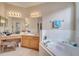 Spacious bathroom with double sinks, a soaking tub, and updated fixtures at 511 Pineloch Dr, Haines City, FL 33844
