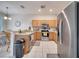 Well-equipped kitchen featuring stainless steel appliances and wood cabinets at 511 Pineloch Dr, Haines City, FL 33844