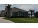 House exterior showcasing curb appeal and lake view at 511 Pineloch Dr, Haines City, FL 33844