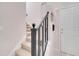 Elegant staircase with a wrought iron railing leading to the upper level at 511 Pineloch Dr, Haines City, FL 33844