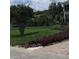 Landscaped front yard with manicured lawn and brick pavers at 511 Pineloch Dr, Haines City, FL 33844