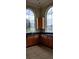 Kitchen with wood cabinets and arched window at 511 Pineloch Dr, Haines City, FL 33844