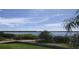 Spacious lake view from screened window, showcasing blue skies at 511 Pineloch Dr, Haines City, FL 33844