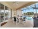 Relaxing patio with seating and grill, overlooking the pool at 511 Pineloch Dr, Haines City, FL 33844