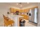 Spacious kitchen with stainless steel appliances and wood cabinets at 511 Pineloch Dr, Haines City, FL 33844