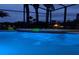 Inviting pool area with blue and purple lighting at night at 511 Pineloch Dr, Haines City, FL 33844