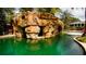 Unique rock grotto features a bridge and access to the pool at 9726 Kilgore Rd, Orlando, FL 32836