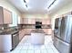 Bright kitchen boasts stainless steel appliances and granite counters at 122 Stone Gable Cir, Winter Springs, FL 32708