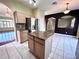 Island kitchen opens to dining area, offering granite counters at 122 Stone Gable Cir, Winter Springs, FL 32708