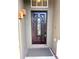 Elegant front door with a dark wood finish and a decorative glass panel at 122 Stone Gable Cir, Winter Springs, FL 32708