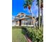 Two-story house with palm trees and a well-maintained lawn at 122 Stone Gable Cir, Winter Springs, FL 32708