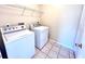 Laundry room features washer, dryer, and overhead shelving at 122 Stone Gable Cir, Winter Springs, FL 32708