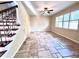 Living room with tile floors, staircase, and window with blinds at 122 Stone Gable Cir, Winter Springs, FL 32708