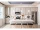 Modern kitchen with white cabinets, center island, and stainless steel appliances at 2424 Park Ridge St, Apopka, FL 32712