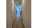 Bright hallway with light wood floors leading to the main living areas at 2021 Crape Jasmine Ln, Orlando, FL 32824