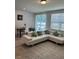 Spacious living room features a white sectional sofa and large area rug at 2021 Crape Jasmine Ln, Orlando, FL 32824