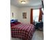 Bedroom with a double bed, desk, and vibrant decor at 2021 Crape Jasmine Ln, Orlando, FL 32824