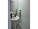 Modern powder room with pedestal sink and elegant fixtures at 2021 Crape Jasmine Ln, Orlando, FL 32824