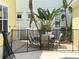 Small patio with table and chairs, fenced in, next to a pool at 7762 Linkside Loop, Reunion, FL 34747