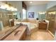 Spacious bathroom with double sinks, a large soaking tub, and separate shower at 7762 Linkside Loop, Reunion, FL 34747
