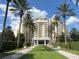 Luxury condo building with palm trees and manicured landscaping at 7762 Linkside Loop, Reunion, FL 34747