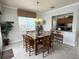 Spacious dining area with a large table and six chairs, kitchen access at 7762 Linkside Loop, Reunion, FL 34747