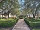 Brick pathway through a lush, tree-lined park area at 7762 Linkside Loop, Reunion, FL 34747
