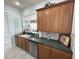 Kitchen boasts stainless steel appliances and dark countertops at 7762 Linkside Loop, Reunion, FL 34747